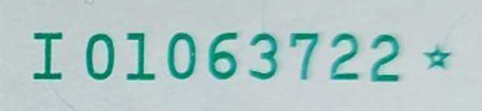 Close-up of the serial number I01063722 on a Series 2003 two-dollar star note, ending in a green star