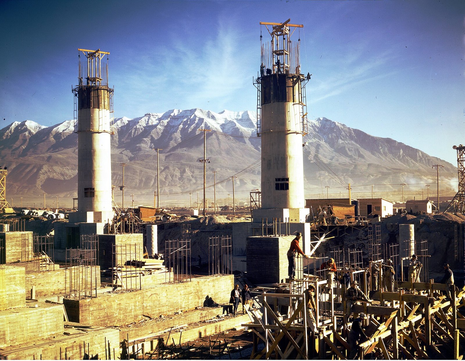 Geneva Steel mill under construction in Utah in 1942, blast furnace stacks against mountains