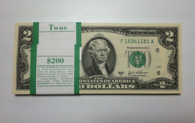 A bank strap of one hundred uncirculated Series 2003A $2 notes with the green Twos $200 band